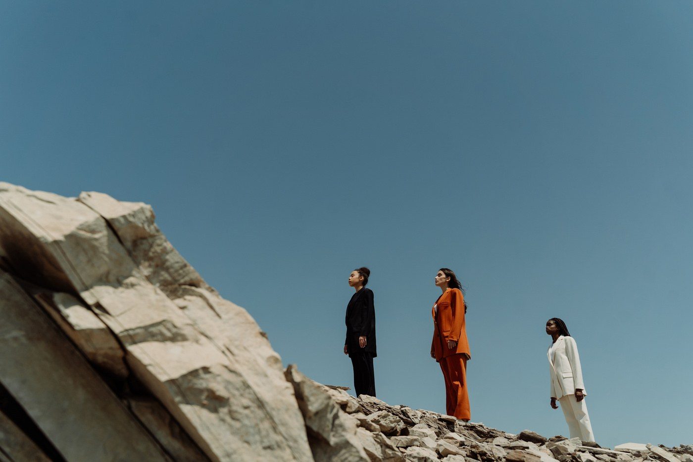 AUREA campaign — trio walking past stone