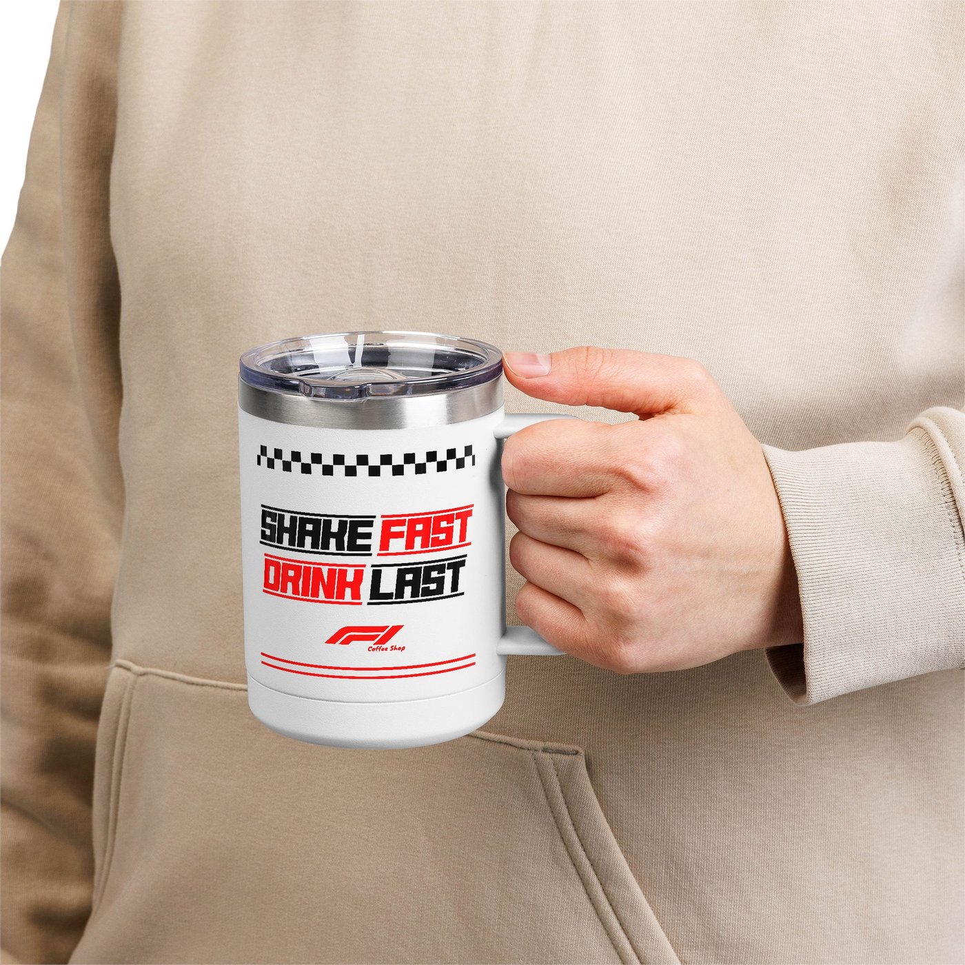 The F1 Coffee mug in hand — checkered flag rim and slogan